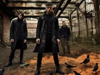 a group of men standing in an abandoned building